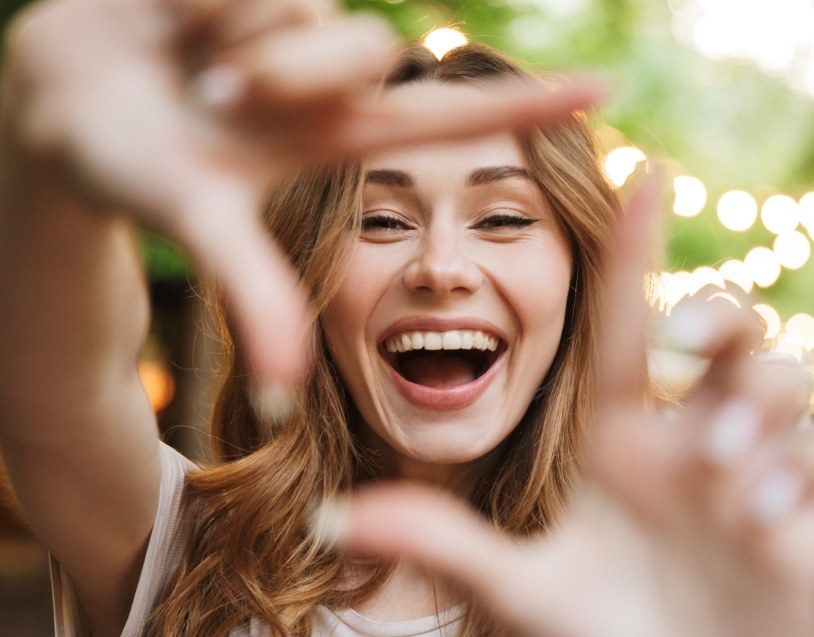 Woman with porcelain veneers showing off her smile