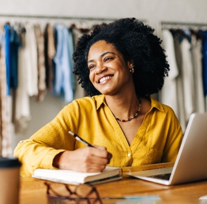 a smiling woman on a laptop