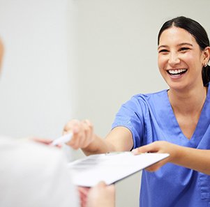 a dental staff member helping a patient apply for financing