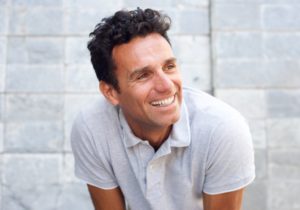 Man smiling while wearing a polo shirt