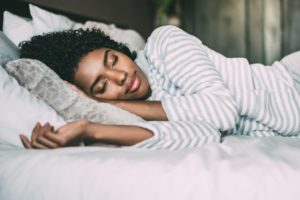 Woman sleeping with white sheets