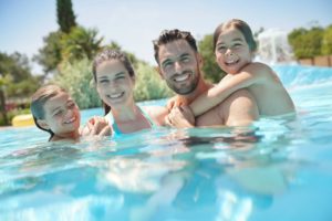 Family playing together in the pool