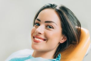Woman with beautiful smile in dental chair