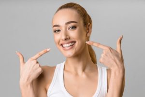 Woman pointing to her white smile