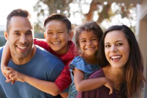 Family smiling together outside