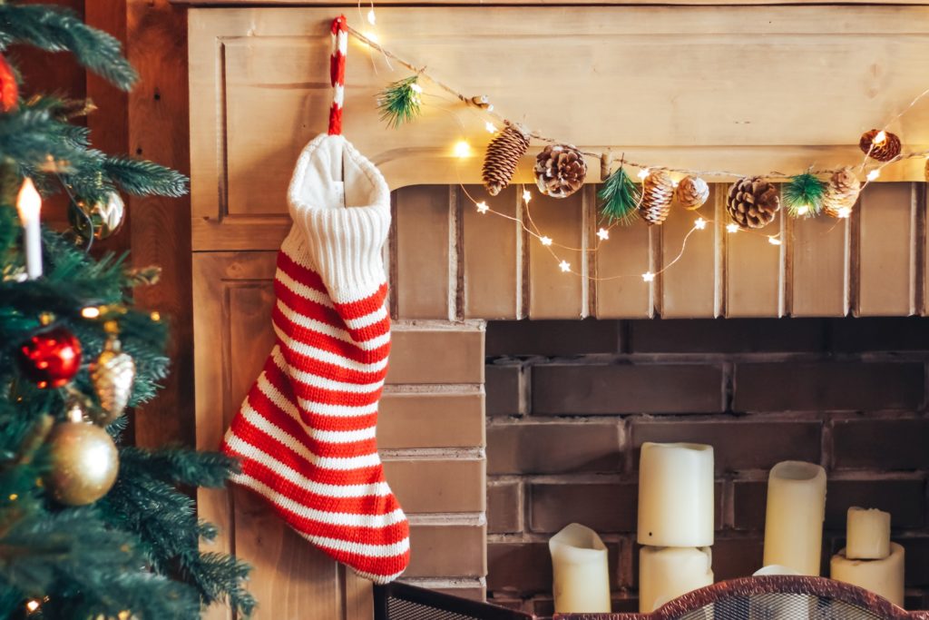 Red and white stocking hung on the fireplace