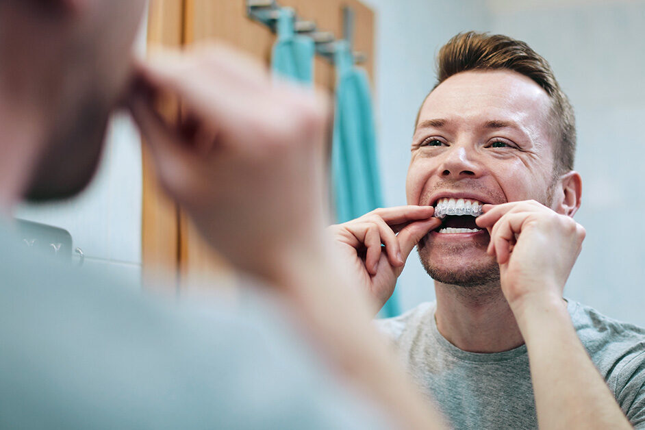 person using over-the-counter teeth whitening products