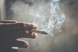 Close up of someone holding a cigarette