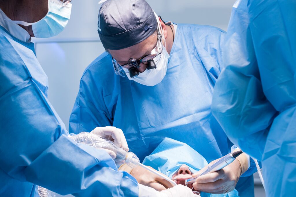 Dentists surgically placing dental implant