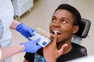 Patient pointing to teeth at dentist's office.