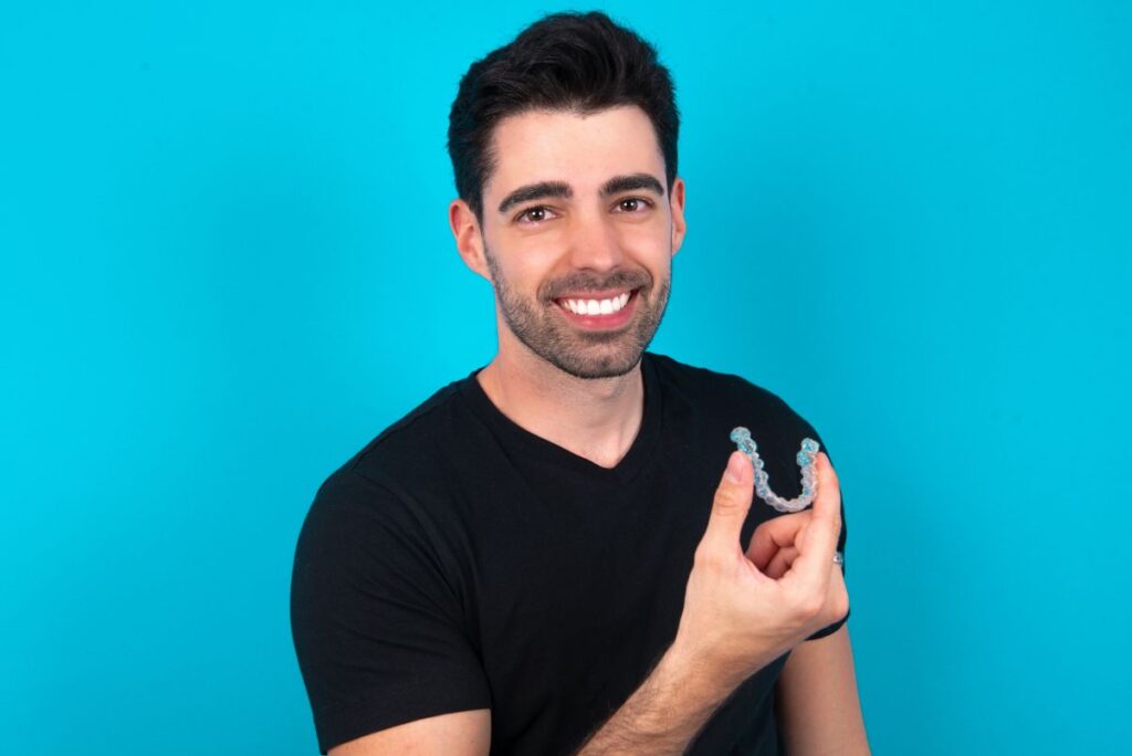 A man holding a ClearCorrect aligner